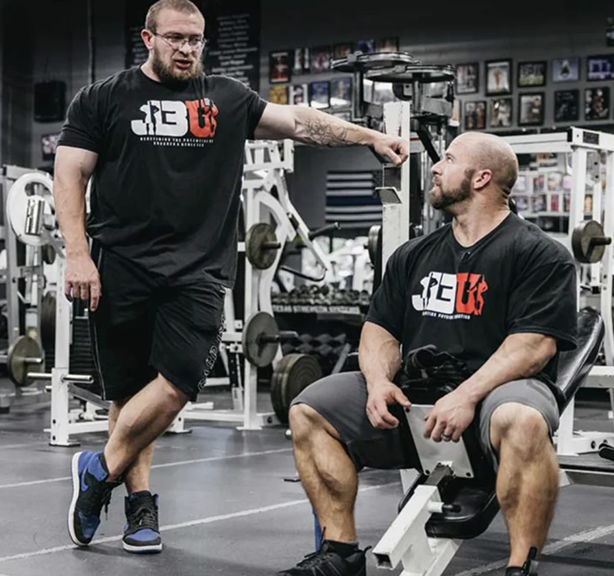 John Jewett coaching a lifter through a working set